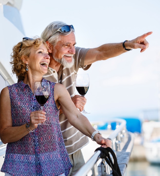 Retired couple on boat drinking wine