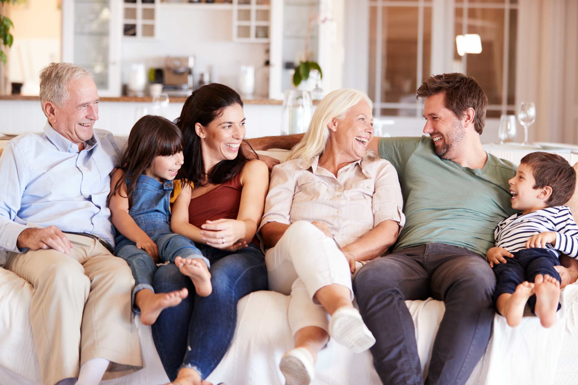 Multi-generation family smiling on couch